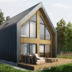 Nowoczesny domek z drewnianymi i grafitowymi elementami, z dużymi oknami, na tarasie meble. Czy na działce rolnej można postawić domek do 70m2?